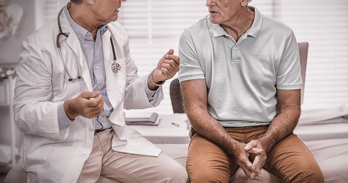 Doctor interacting with senior patient in clinic