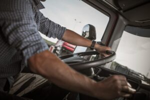 Transportation and Automotive Industry. Commercial Driving. Caucasian Truck Behind the Wheel.
