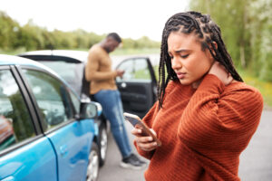 a woman holding her phone after a car accident
